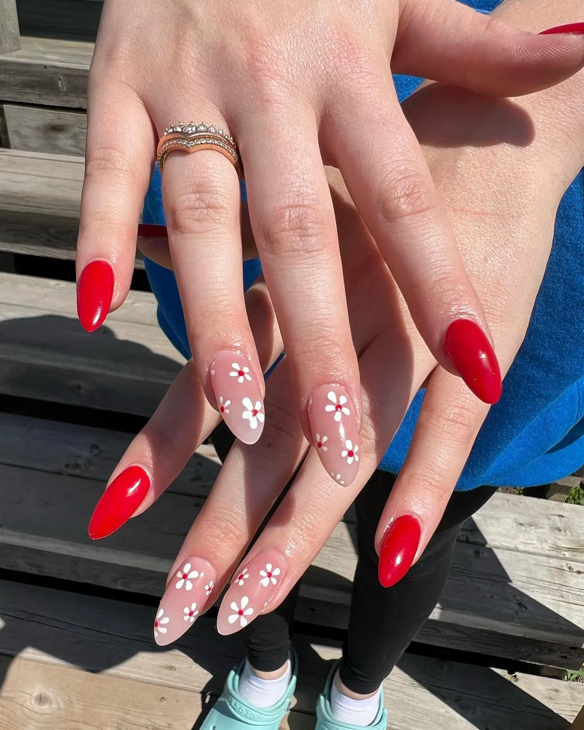 Bright red with nude-and-daisy accent nails