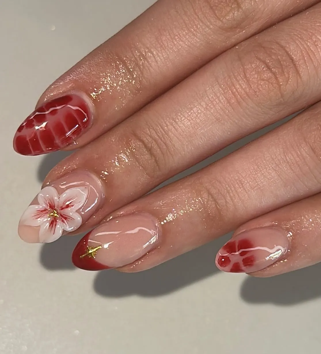 Red French tips with marbling and floral detail