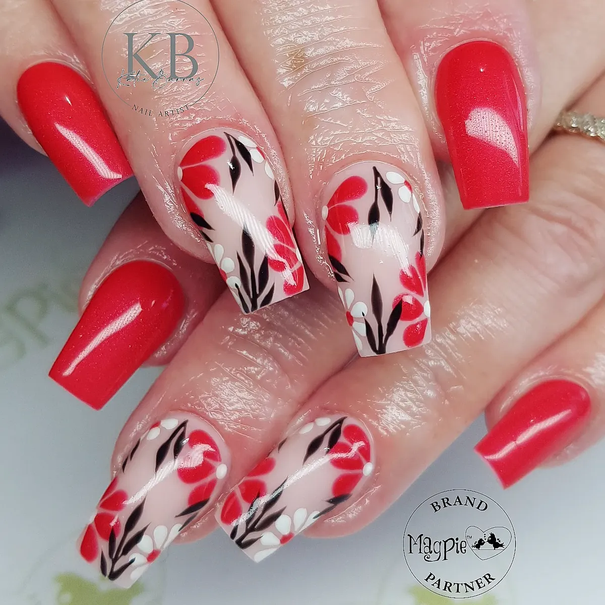 Long red set with nude floral-and-leaf nail art