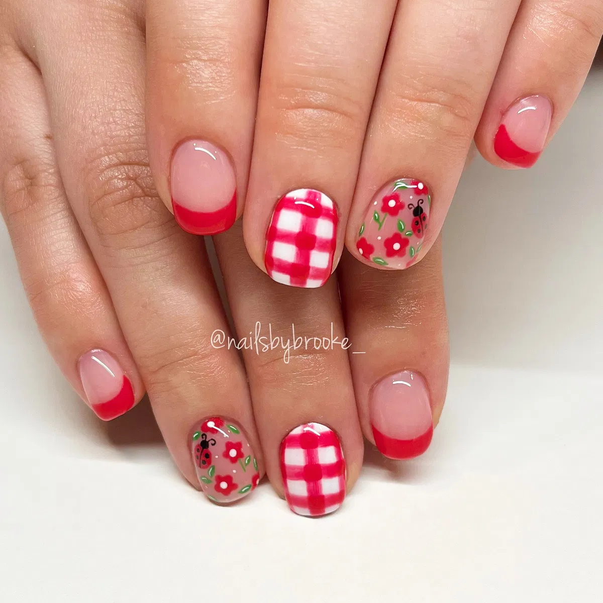 Red French tips with gingham and floral accents