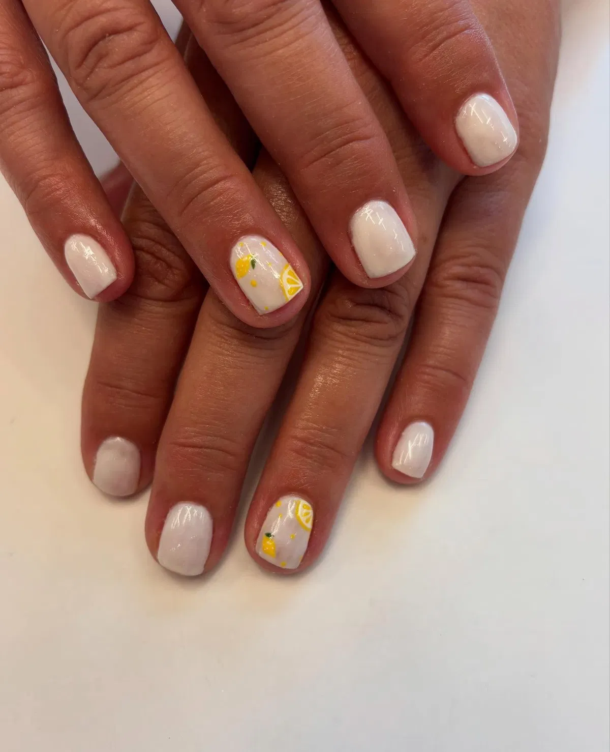 White nails with minimal lemon wedge accents