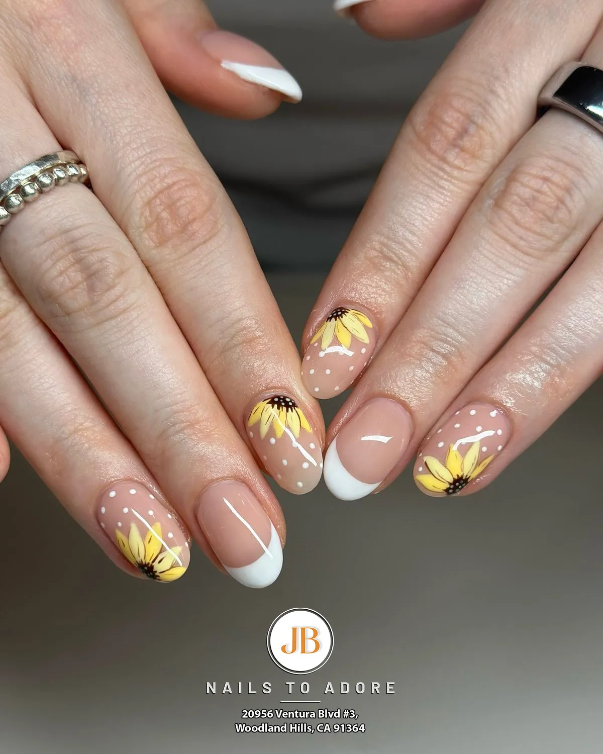 Nude polka dots with sunflower accents and a white French tip