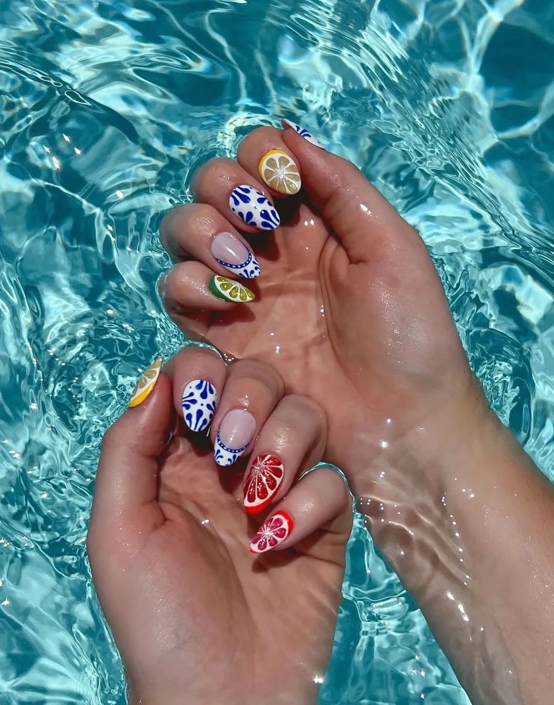 Blue pattern nails with citrus slice art
