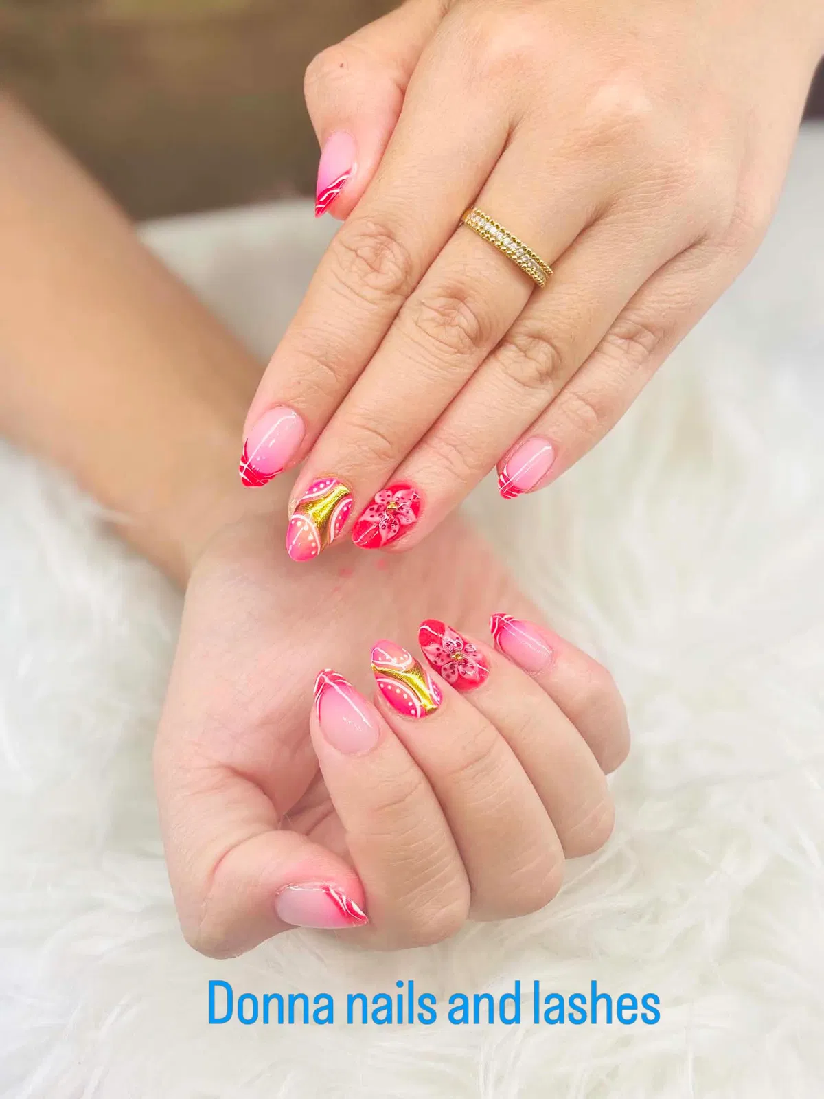 Bright pink French with white linework and floral accents