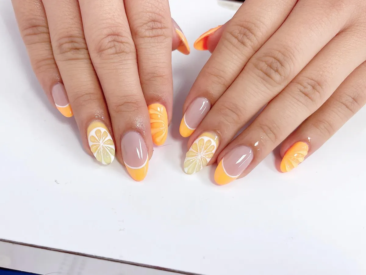 Orange French tips with citrus-slice accents