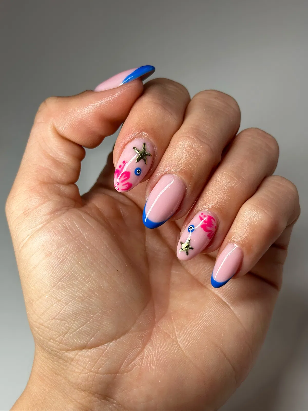 Blue French tips with starfish and abstract pink accents