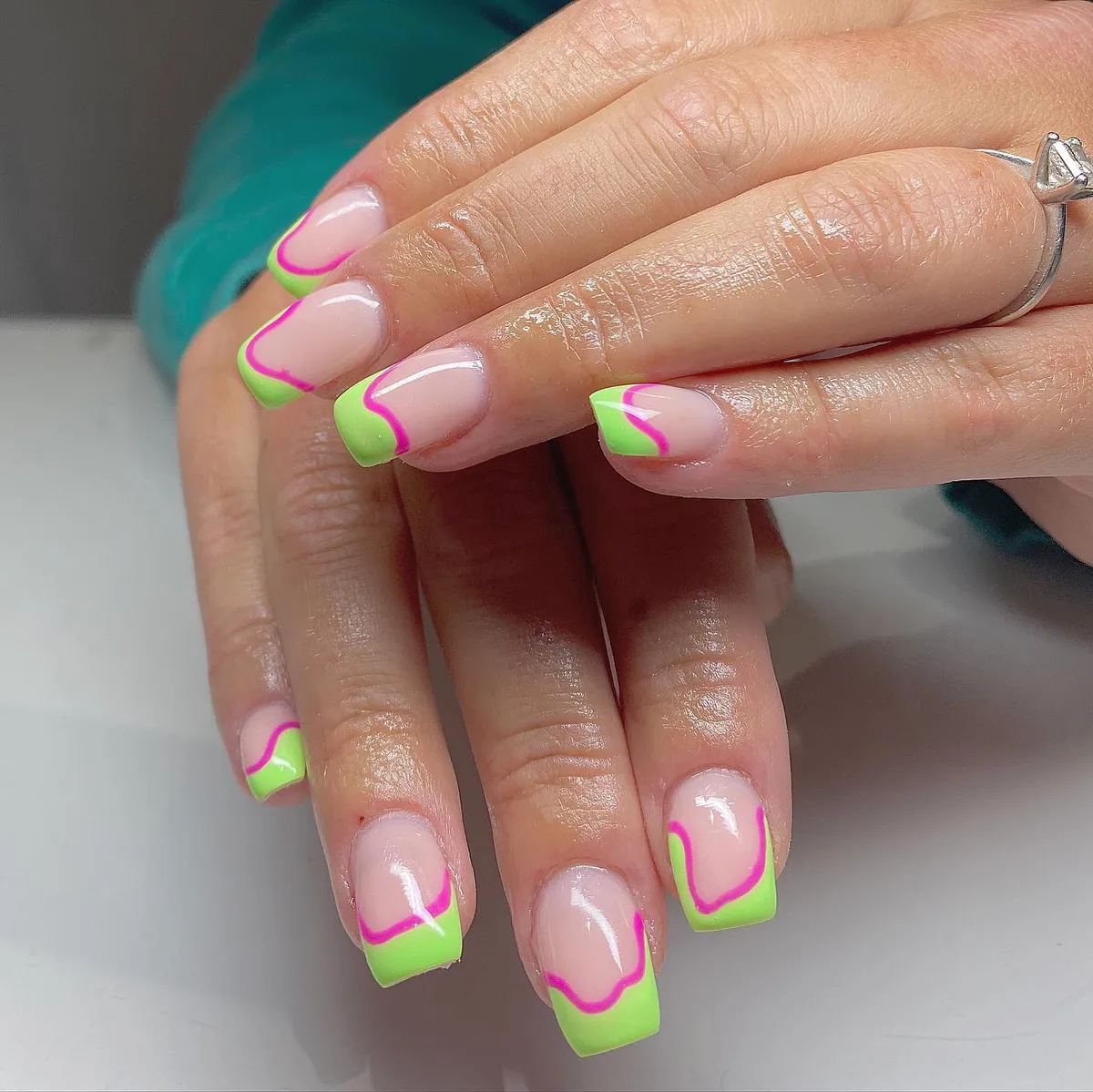 Neon green French tips with hot-pink wavy outline