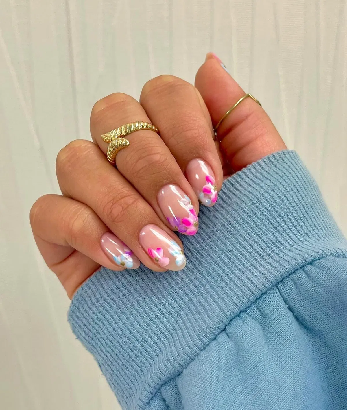 Sheer nude base with pink-purple petal accents and gold dots