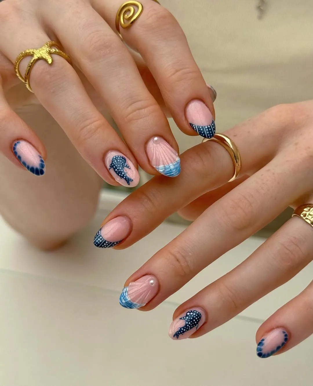 Navy patterned tips with spotted sea-creature silhouettes and shell detail