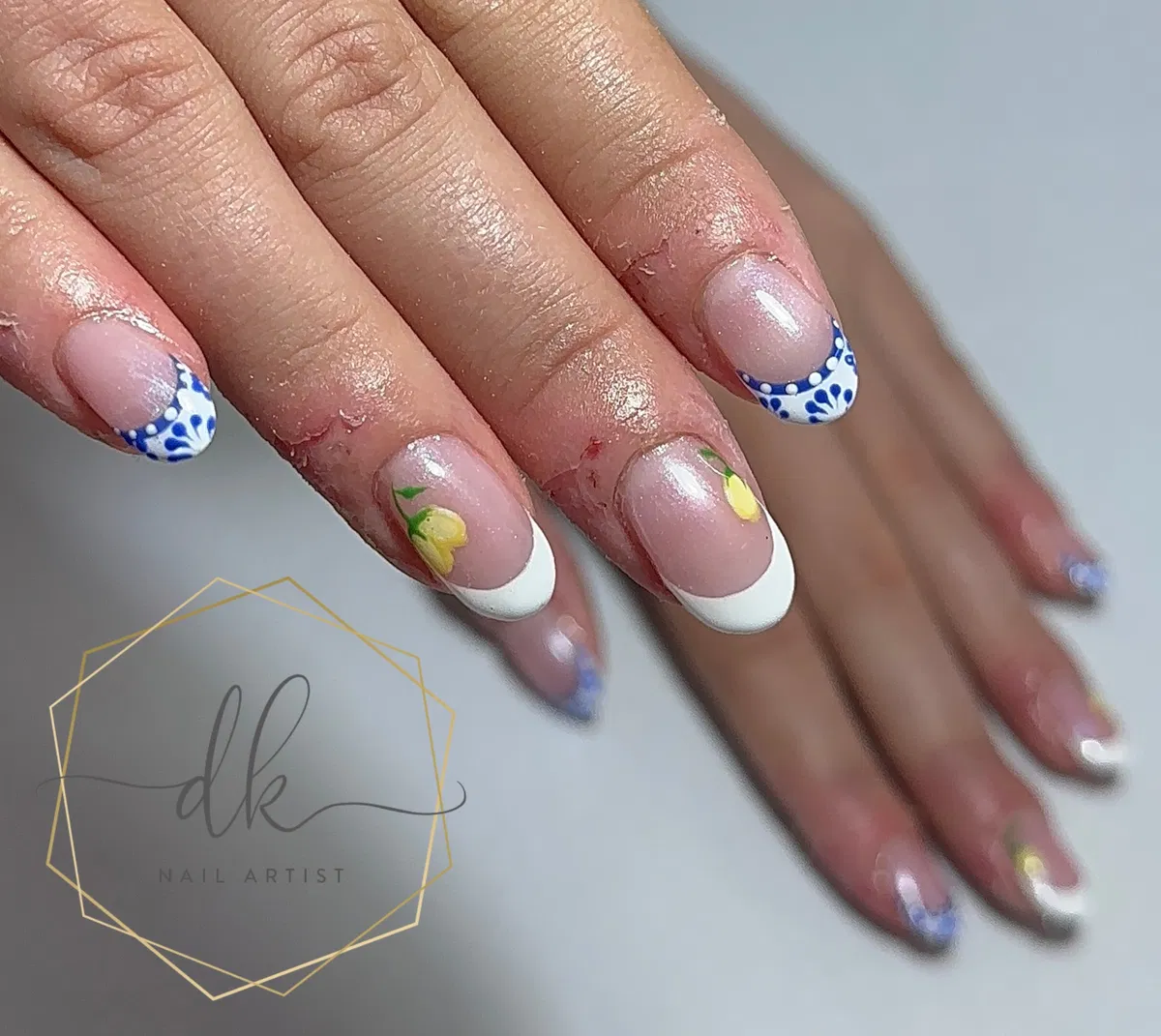 Sheer nude French tips with blue patterning and lemon details