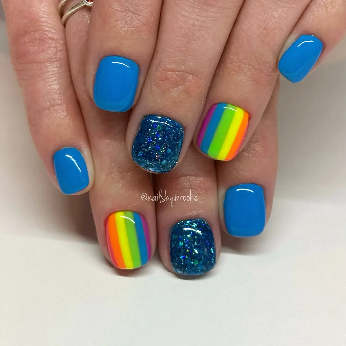 Bright blue with rainbow stripes and glitter accents