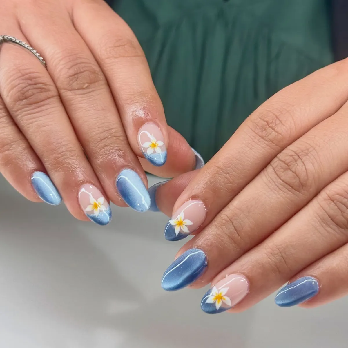 Blue ombré tips with white floral accents