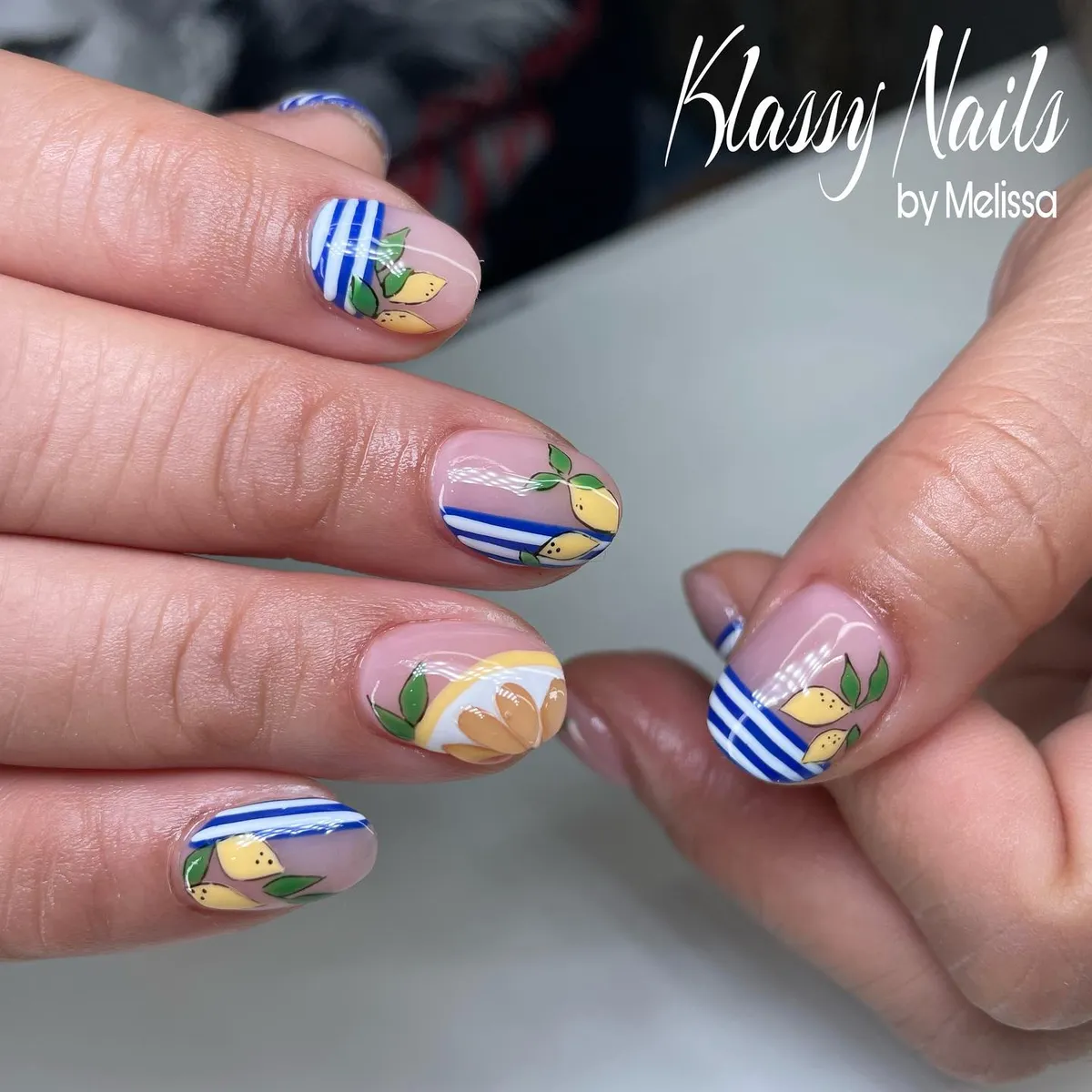 Blue striped tips with tiny lemons on a nude base