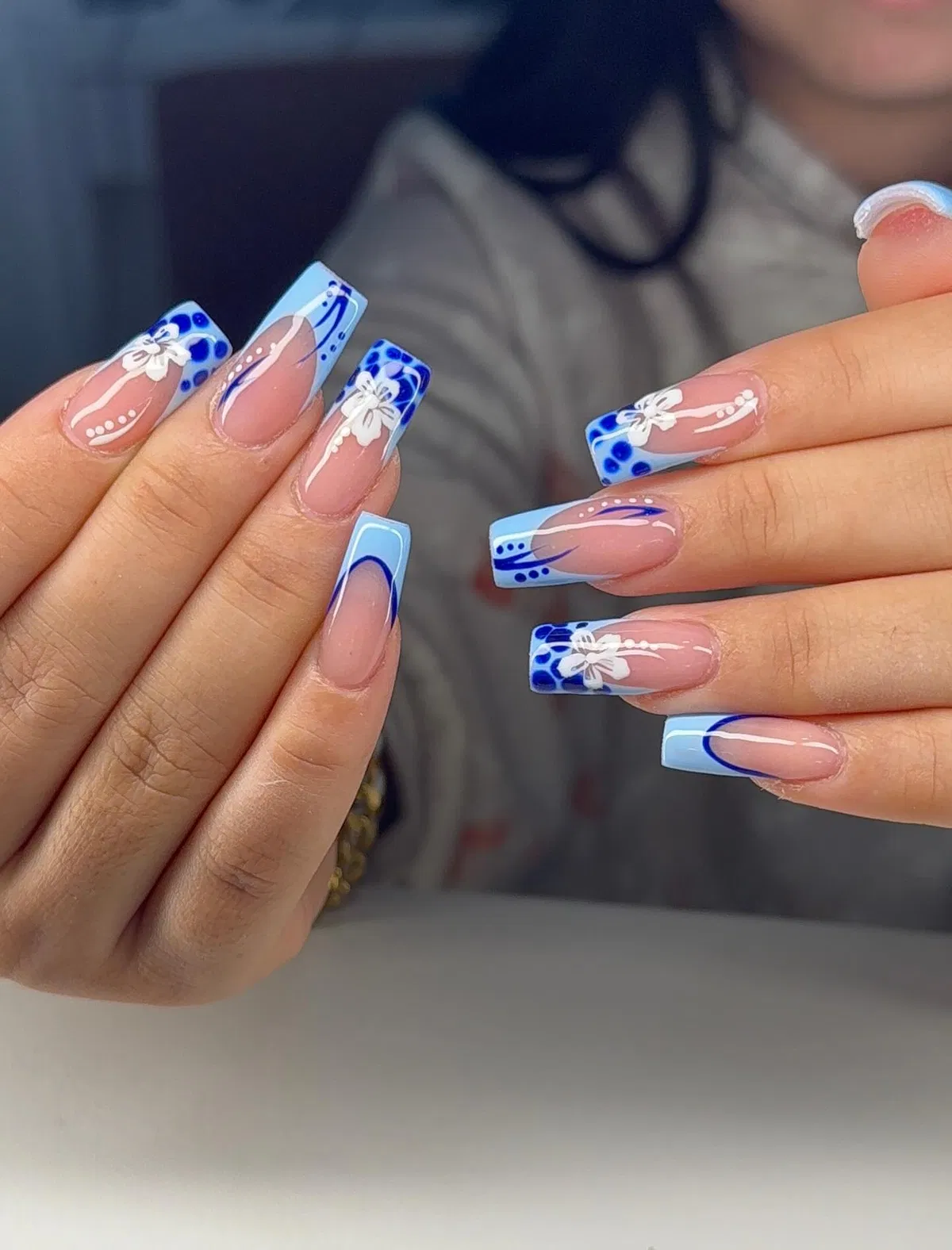 Light blue French tips with white bows and blue dots