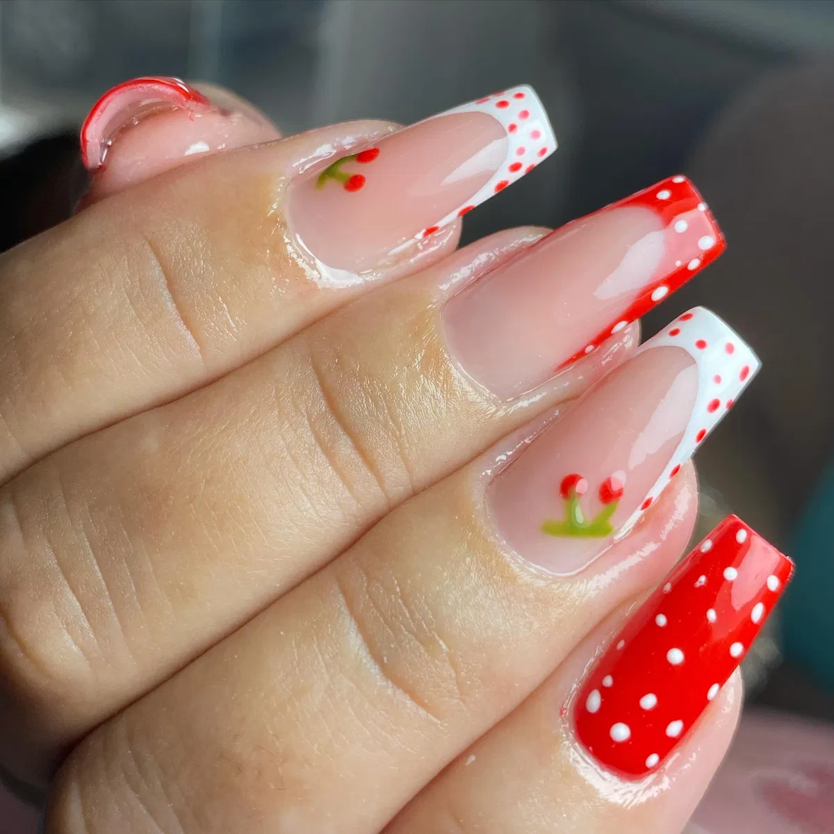 Red-and-white polka dot tips with cherry motifs