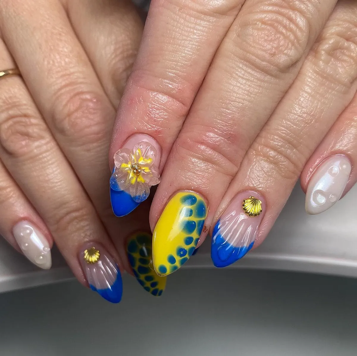 Blue-and-yellow set with 3D flower, gold shells, and droplet accents