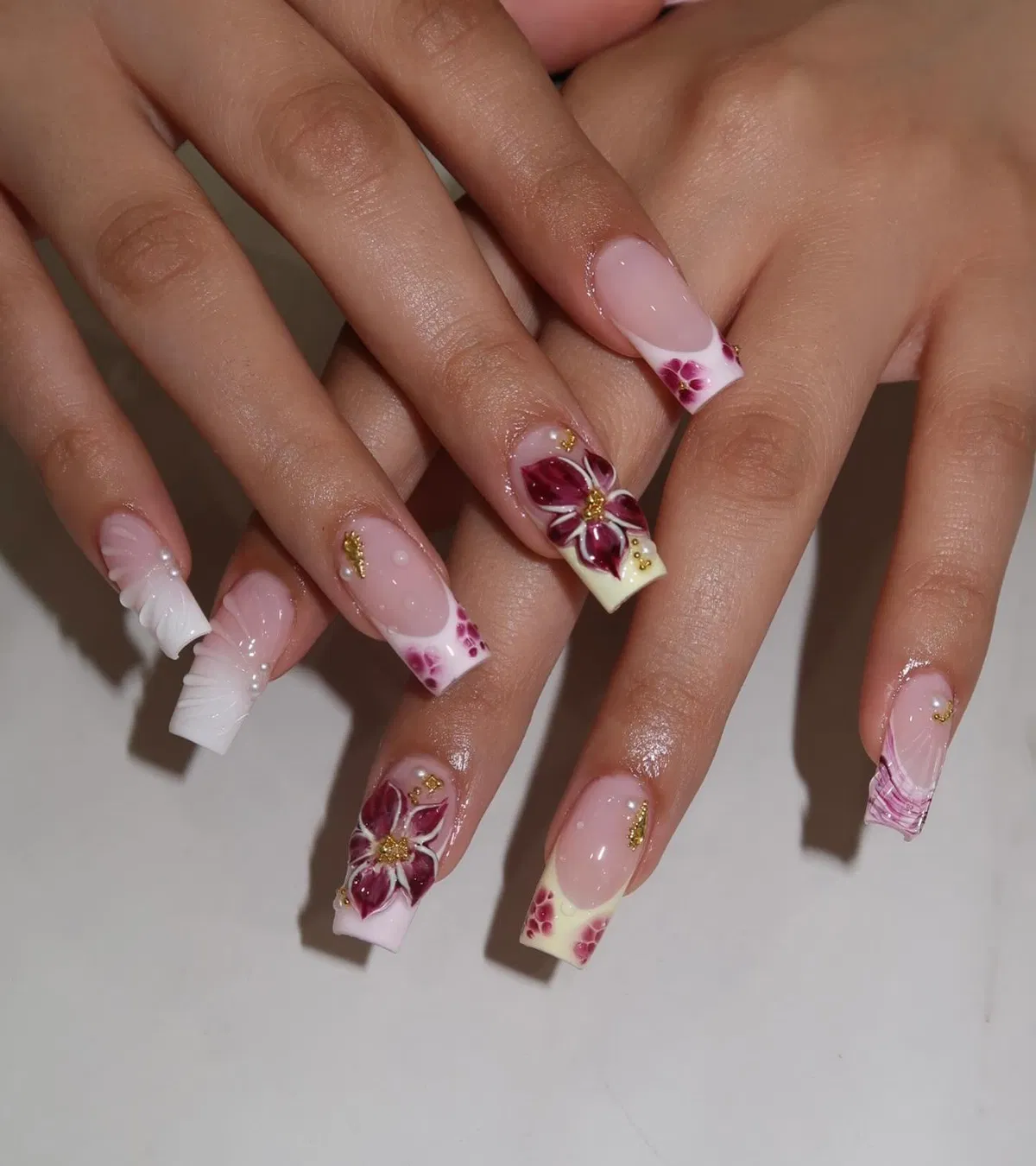 Purple floral corners with white/cream tips and gold accents