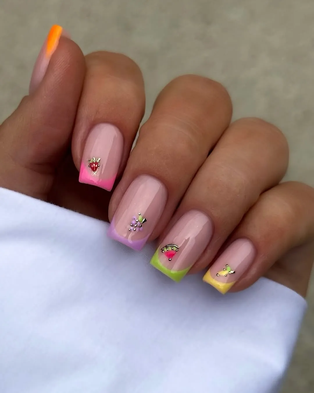 Pastel square tips with tiny fruit and rhinestone accents