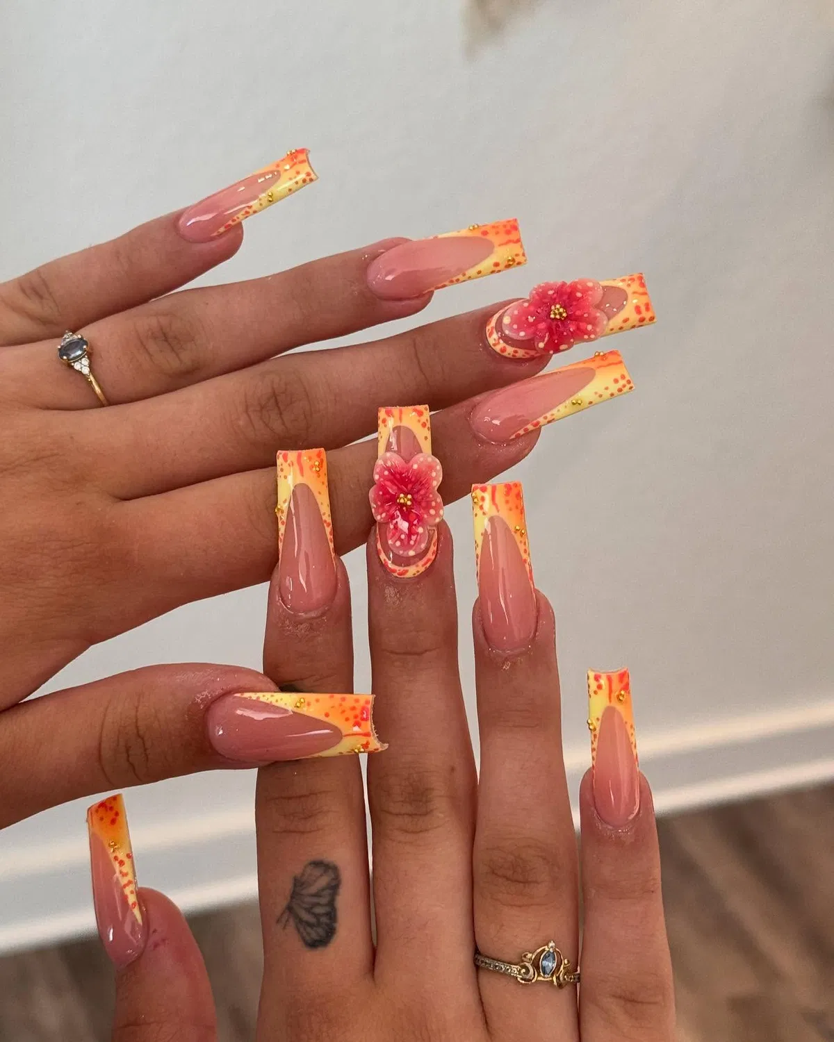 Speckled orange-yellow square tips with 3D pink flowers