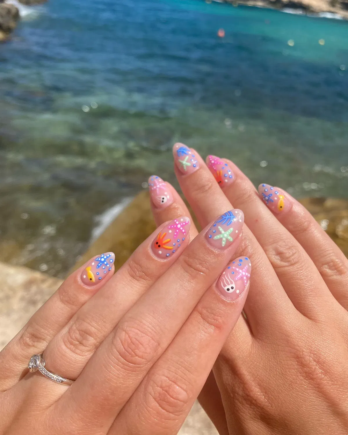 Playful sea-creature doodles over a sheer nude base