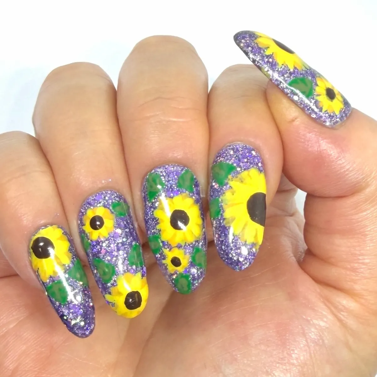 Purple glitter base with bold sunflower-and-leaf art