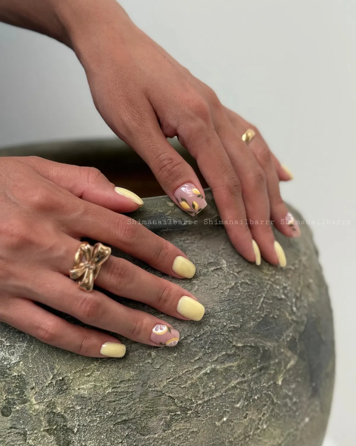 Pale yellow set with mauve accent nails and petal motifs