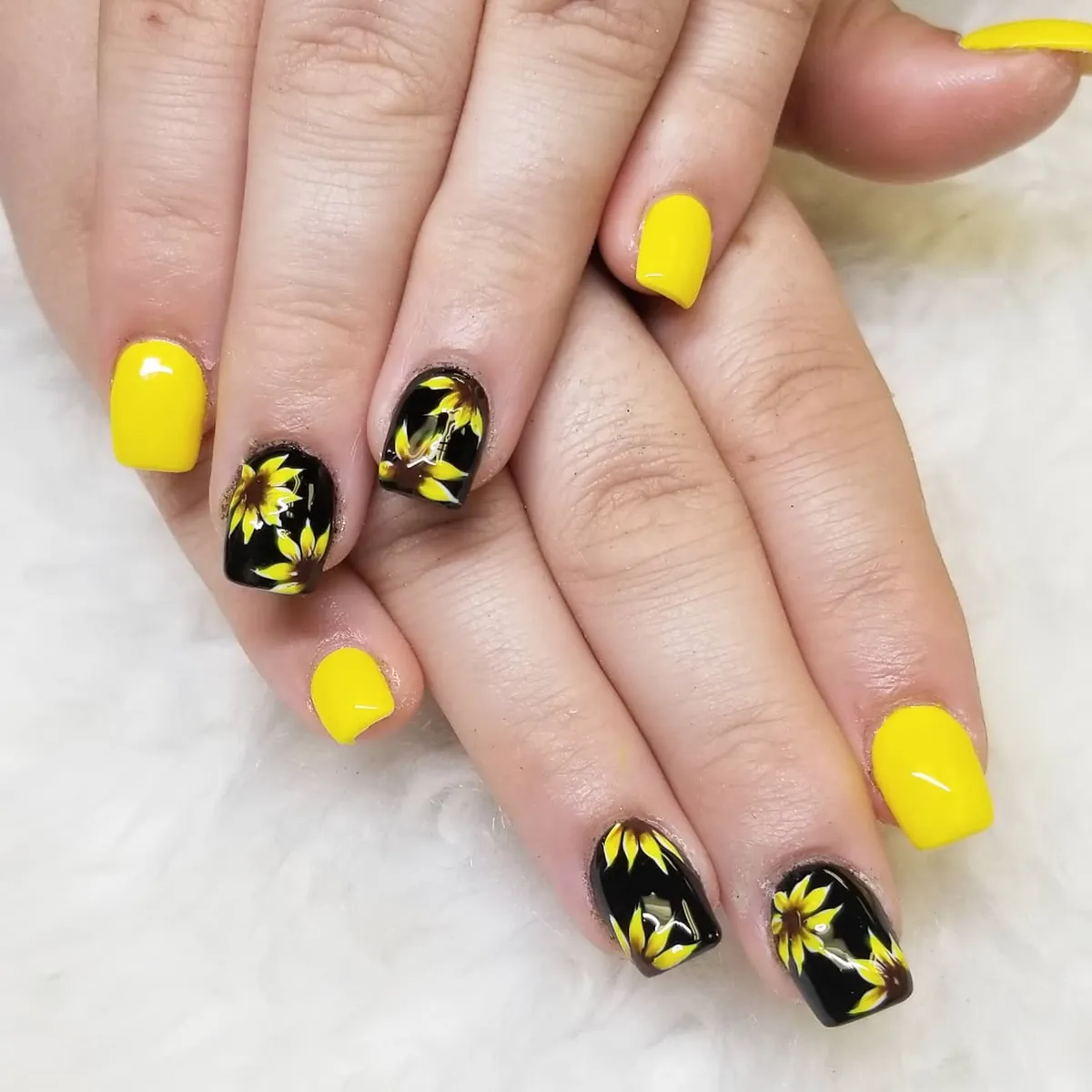 High-contrast yellow and black sunflower nails