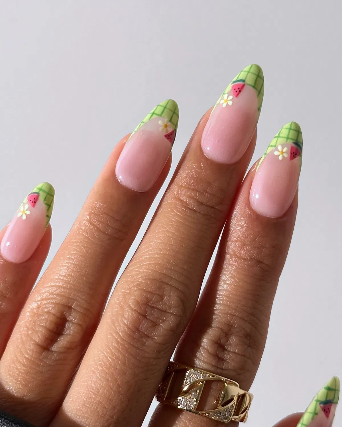 Green grid French tips with tiny flowers and pink motifs