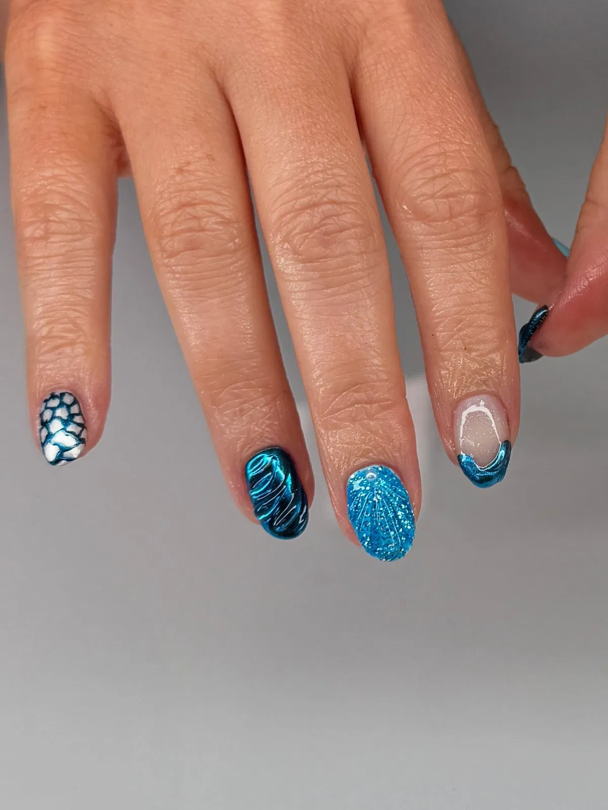 Blue mix: scale pattern, reflective blue, and glitter accent