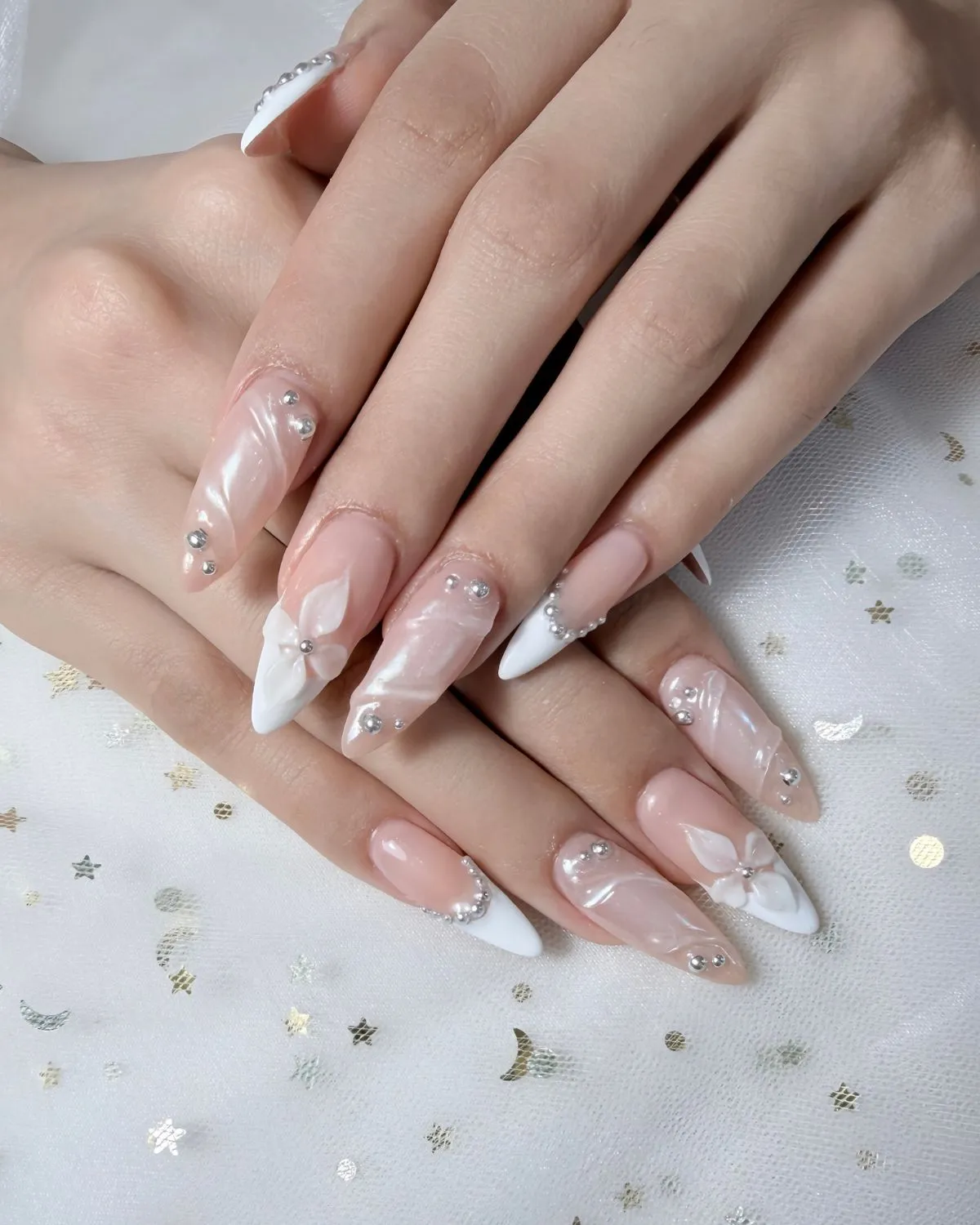 Stiletto French tips with rhinestones and 3D flowers
