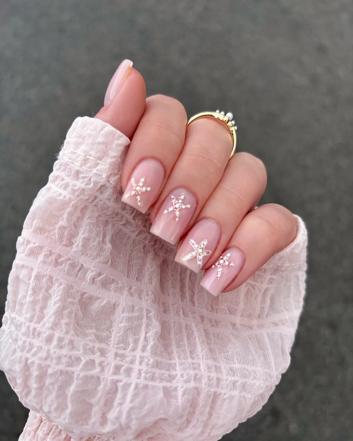 Pale pink squares with pearl-style starfish motifs