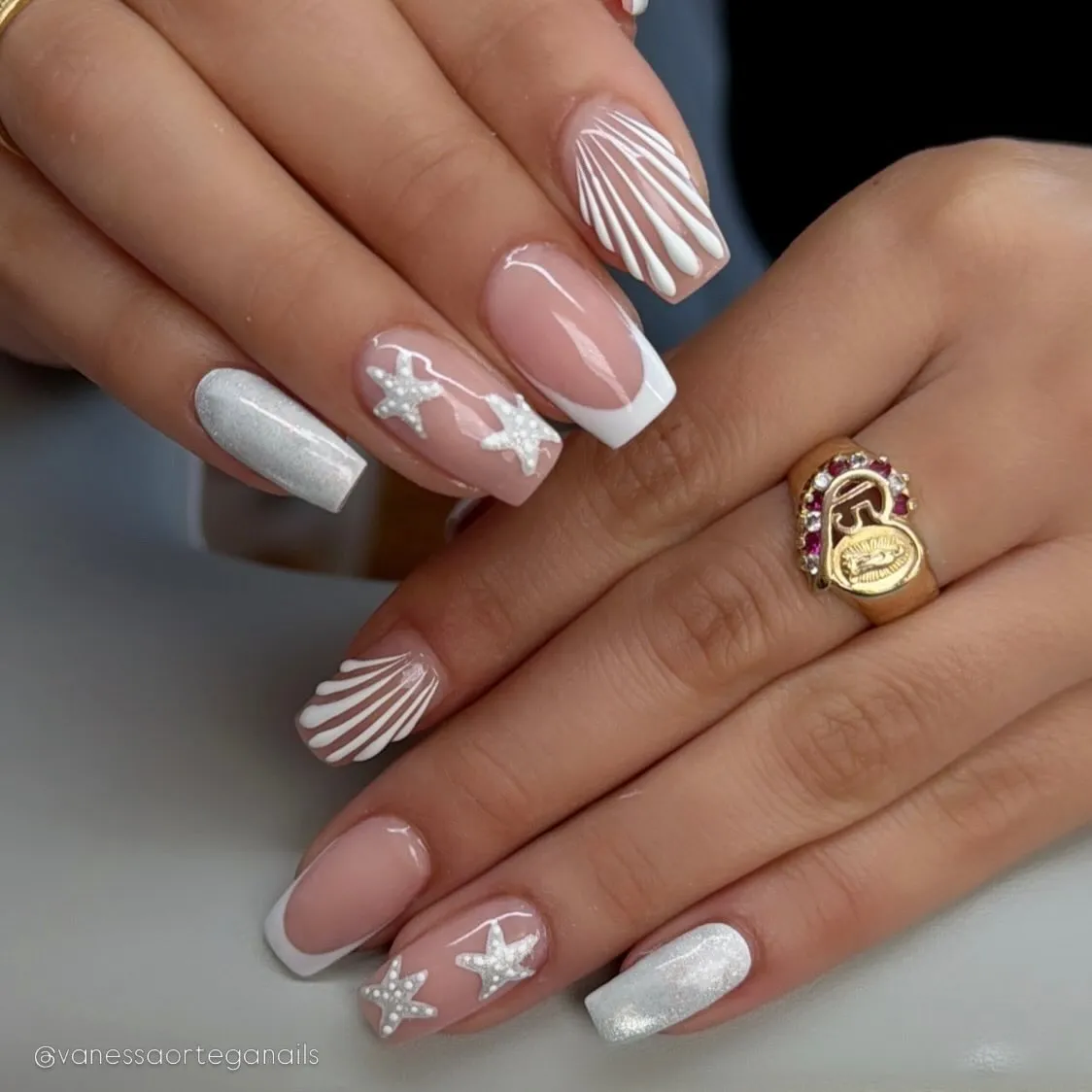 Square French tips with shell lines, starfish accents, and a silver shimmer nail