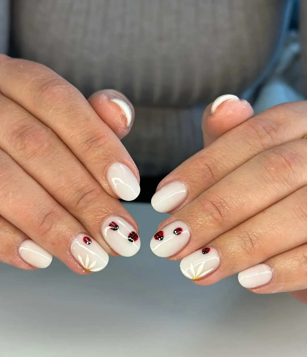 Milky white nails with ladybugs and daisies