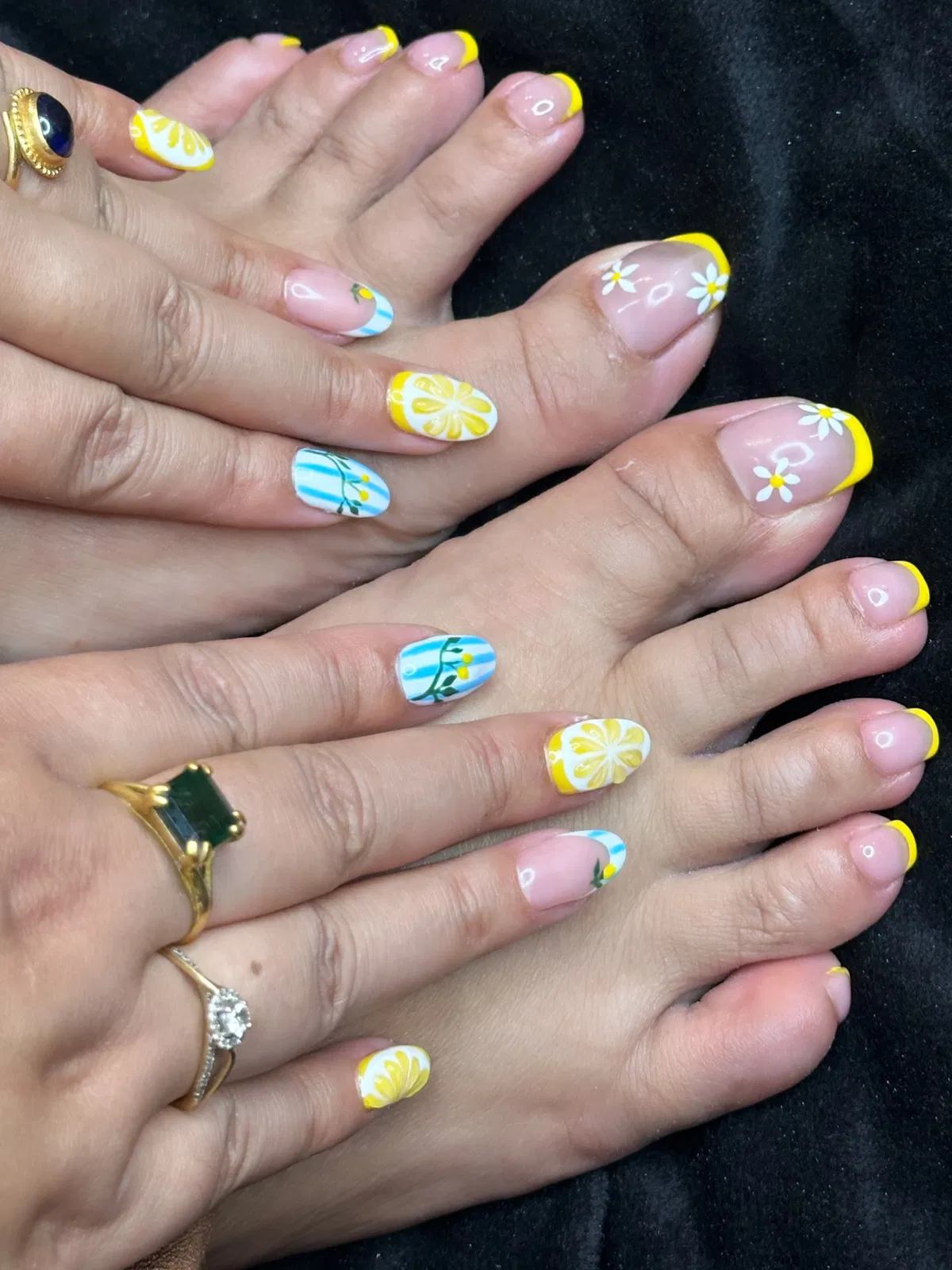 Yellow French tips with daisies and citrus-style accents