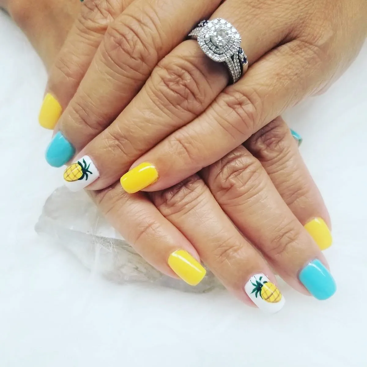 Yellow and turquoise nails with pineapple accents