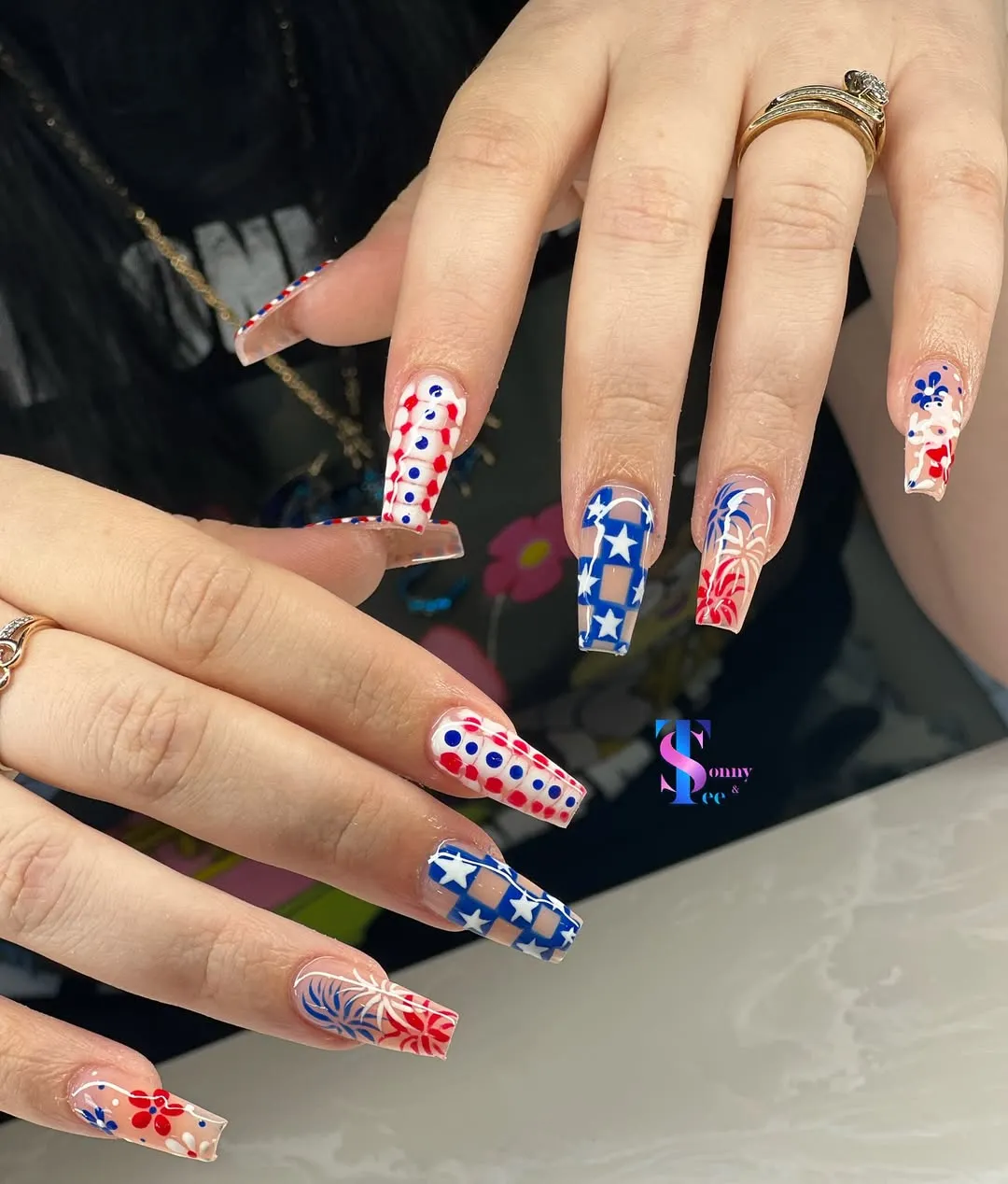 Long coffin nails with checkerboard stars and burst-line art