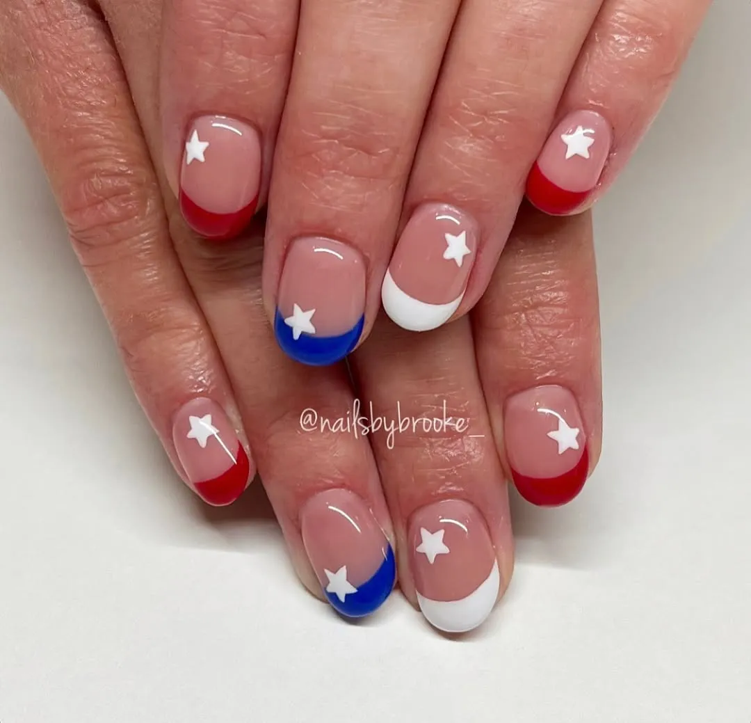 Nude French tips with single white star accents