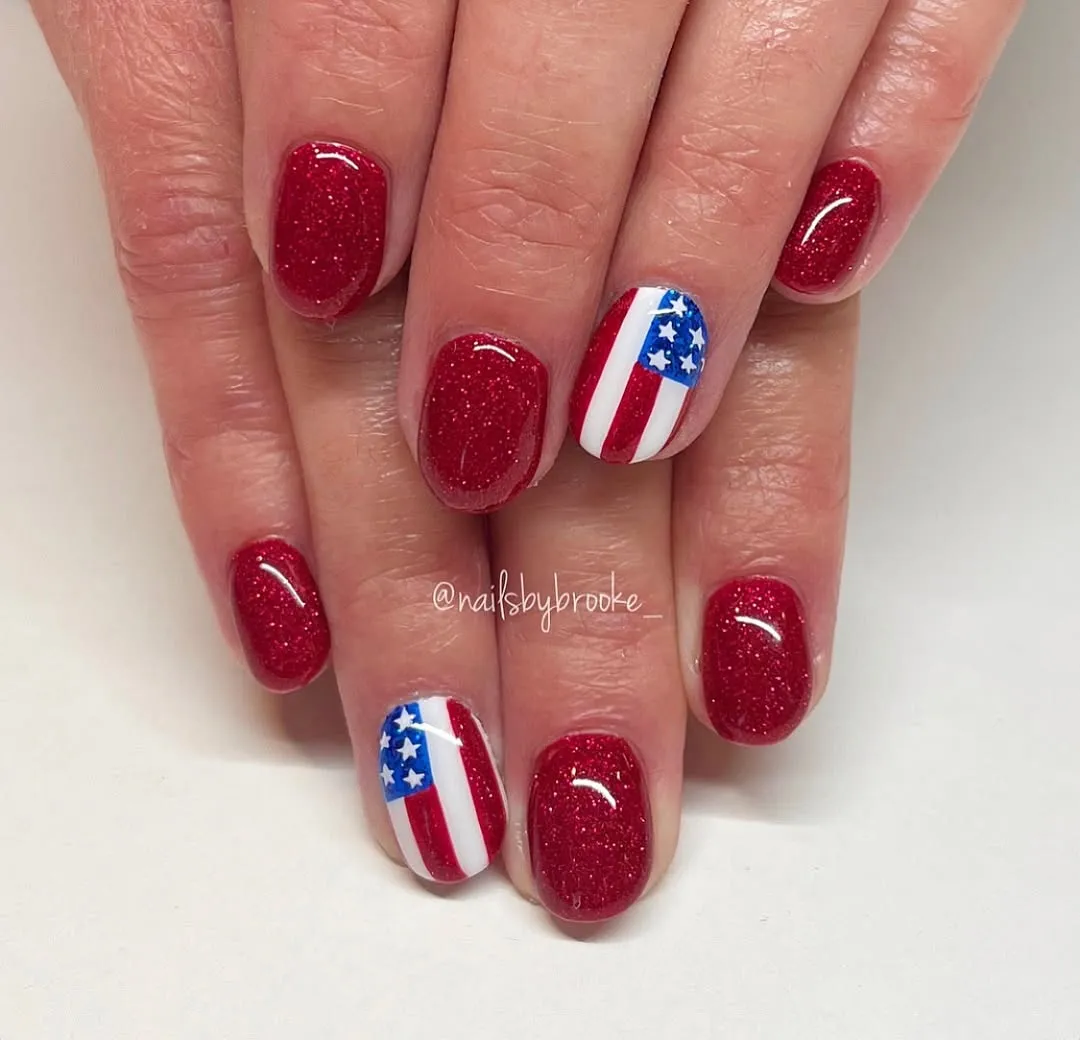 Deep red sparkle with striped-and-star accent nails
