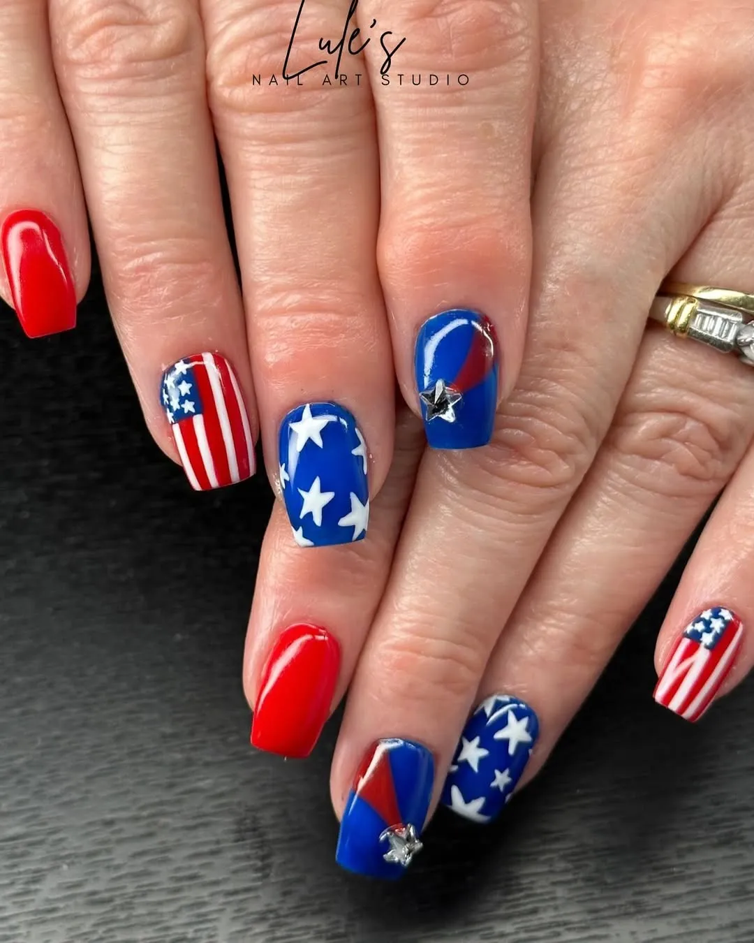 Mixed red solids, star prints, and striped accent with star charm