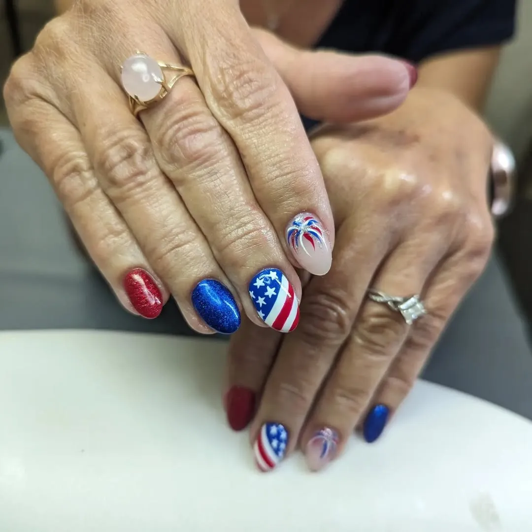 Almond nails with metallic blue and a star-and-stripe accent