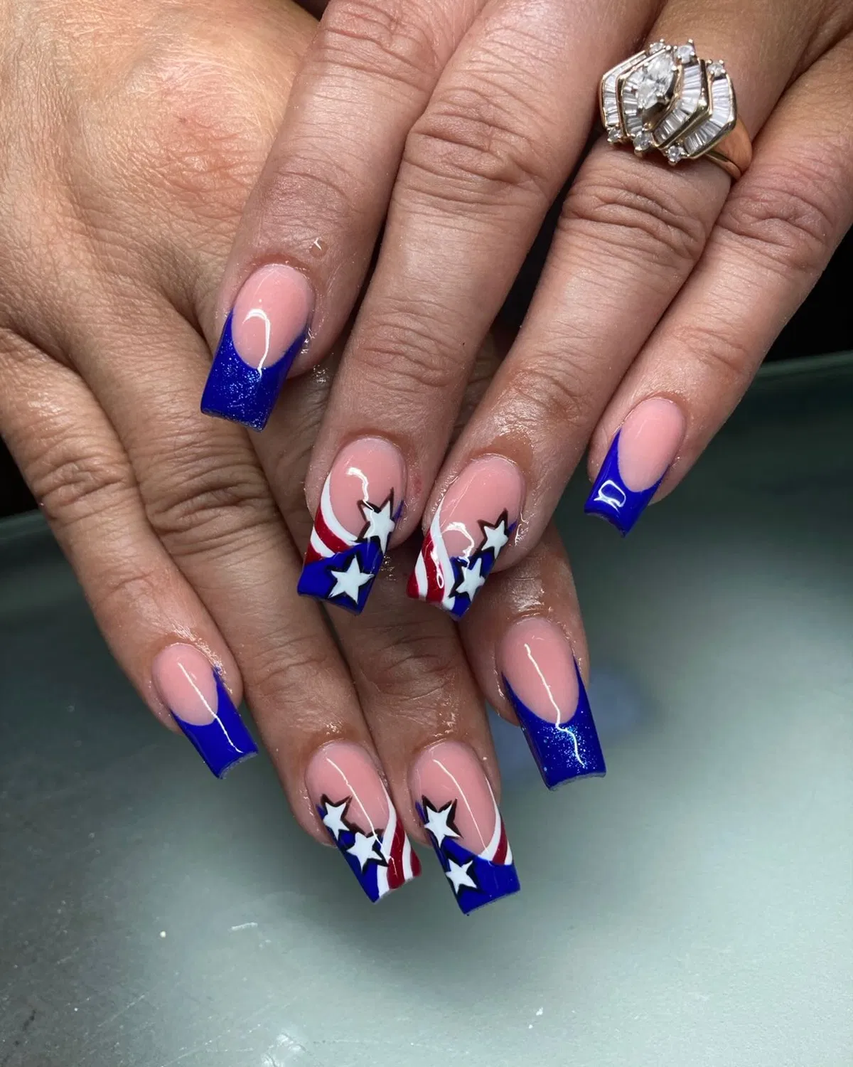 Blue French tips with white stars and red stripe accents