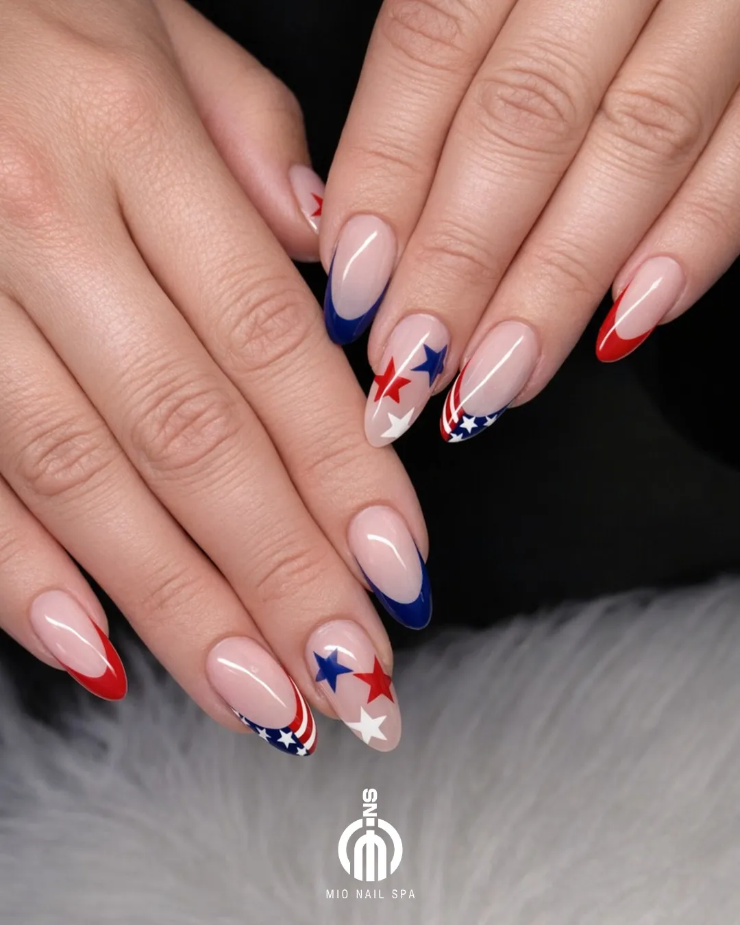 Almond French tips with stars and a striped-and-star accent