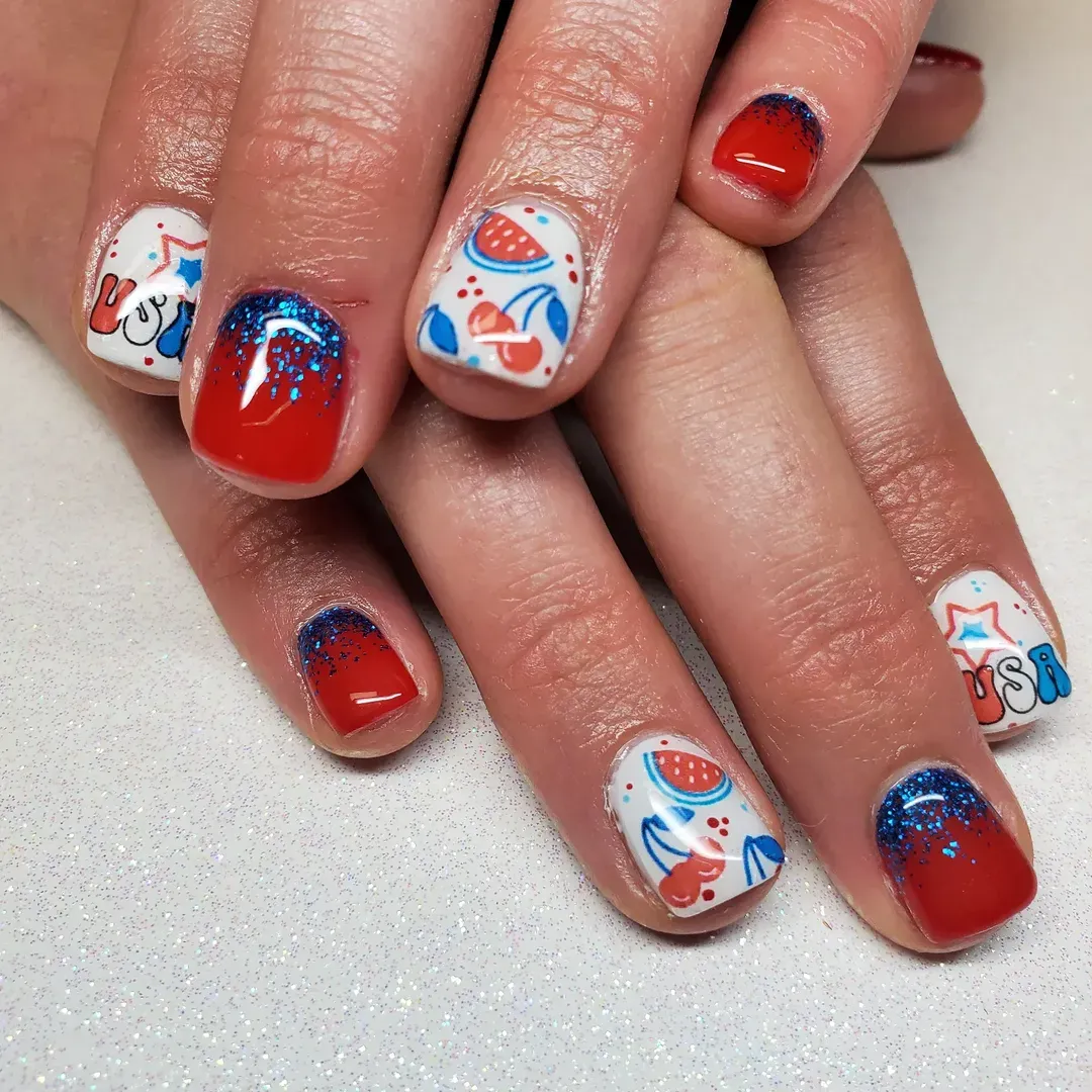 Red nails with blue glitter and white graphic accent nails