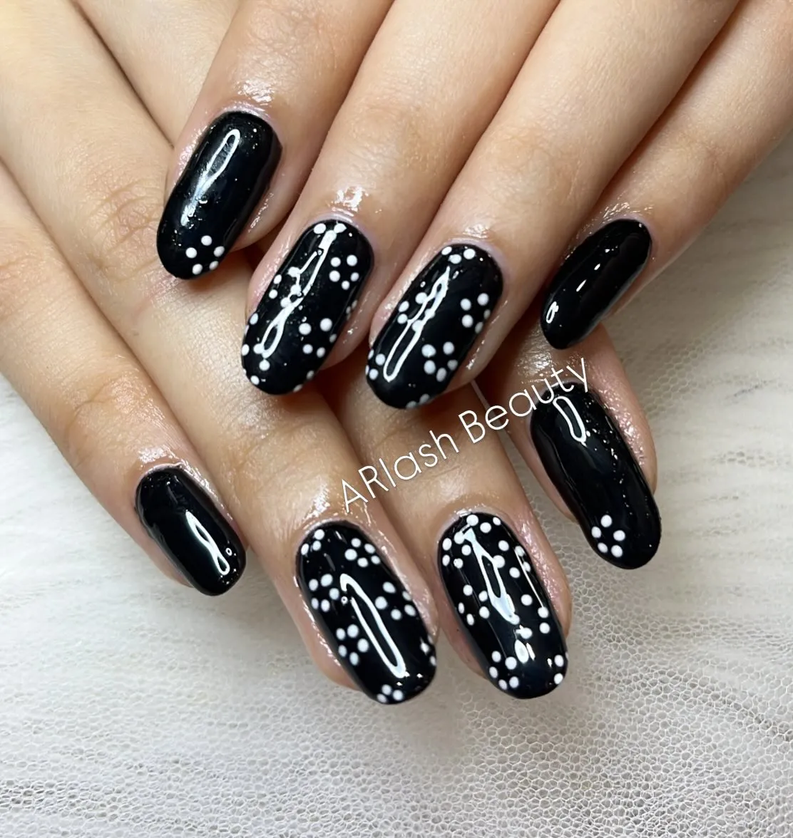 Glossy black base with white polka dots