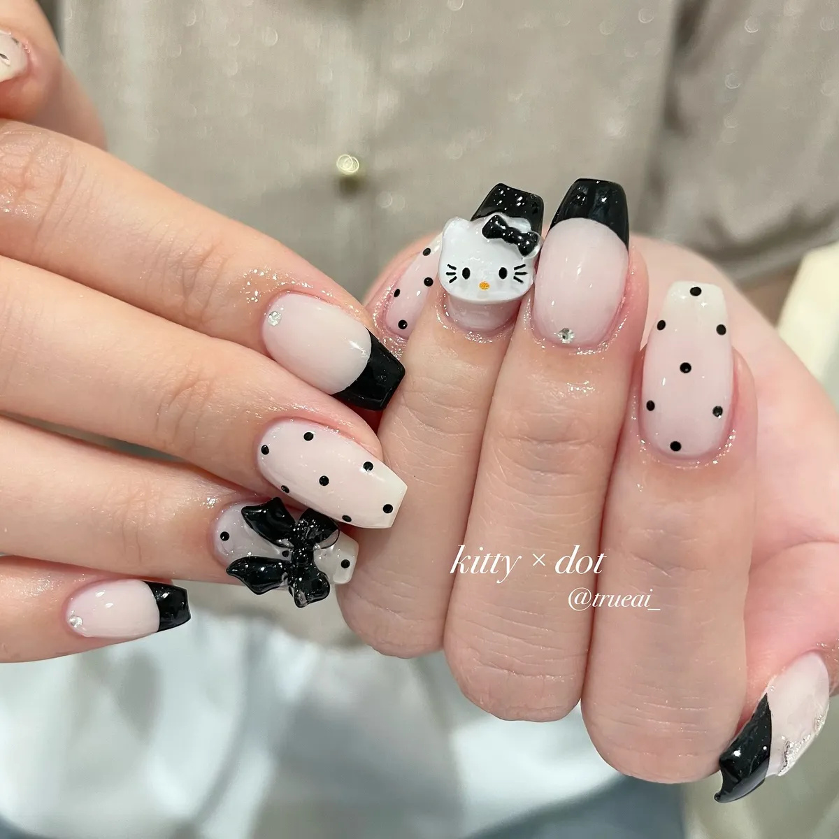 Black French tips with polka dots and 3D cat/bow accents