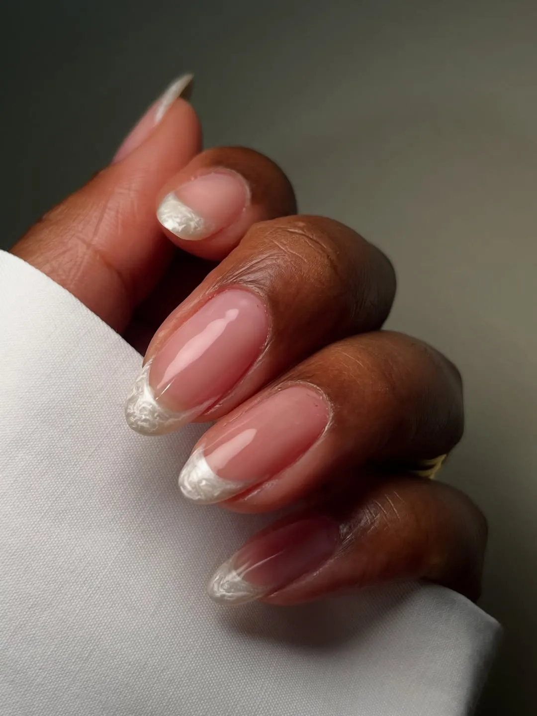 Nude-pink base with marbled white French tips