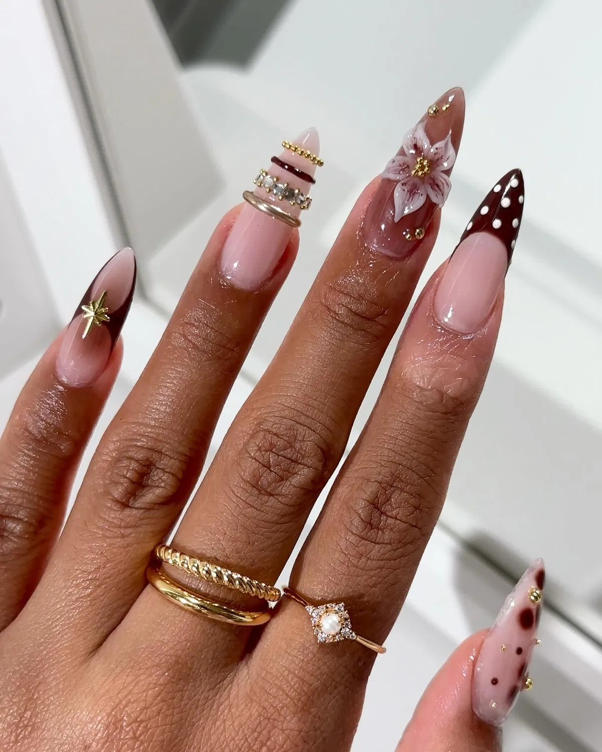 Brown polka-dot tip with floral nail and gold star charm