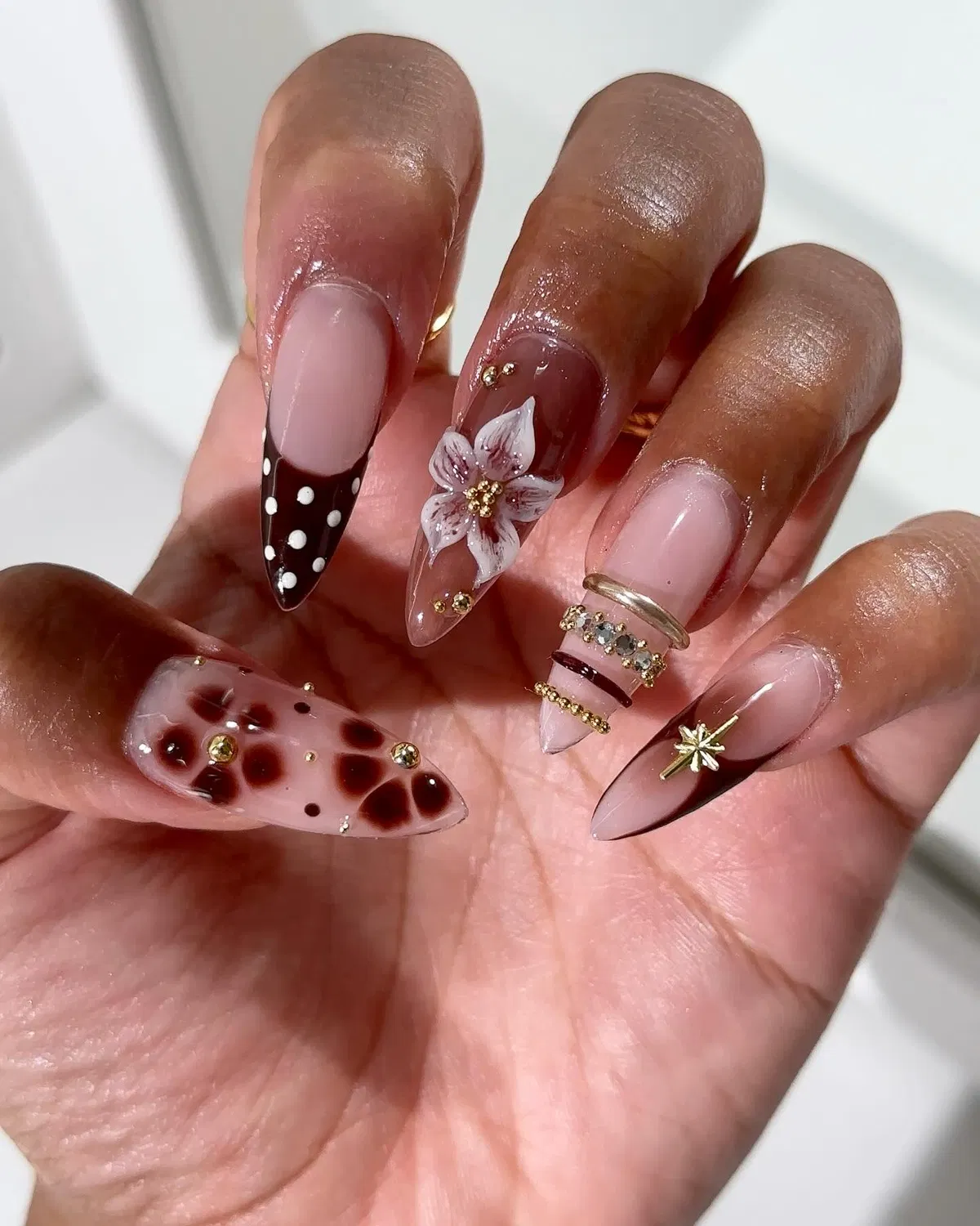 Brown polka-dot tip with floral and spotted accent nails