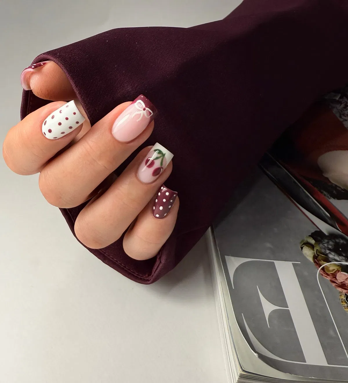 Burgundy polka dots with bow and fruit accents