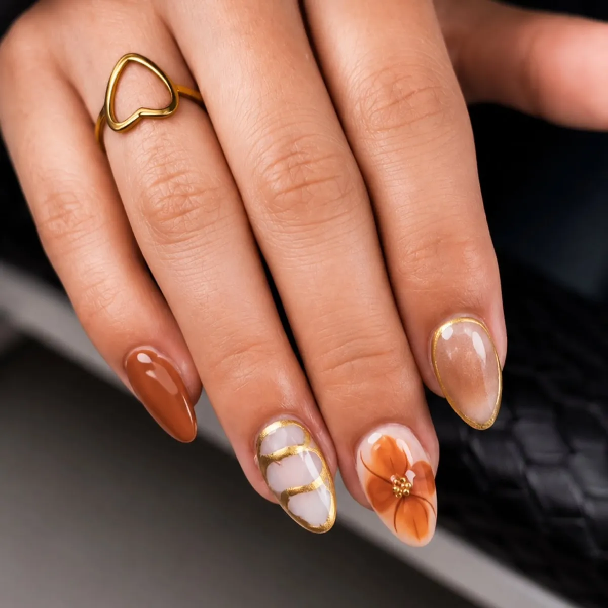 Burnt orange with gold outlines and floral accent